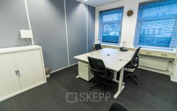 Modern office space rental at Siriusdreef 17, Hoofddorp featuring a clean desk, chairs, and storage cabinets for a professional setting.