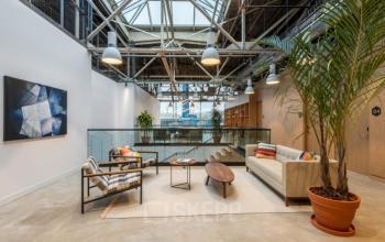 Modern office lounge with stylish furniture, plants, and natural light at Siriusdreef 17, ideal for office space rental in Hoofddorp.