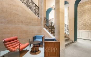 Stylish office entrance at Siriusdreef 17, Hoofddorp featuring modern seating and elegant stairway. Ideal for office space rental.