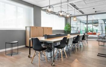 Modern office space rental with large windows, stylish lighting, and sleek furniture at Siriusdreef 17, Hoofddorp. Ideal for businesses seeking a contemporary environment.