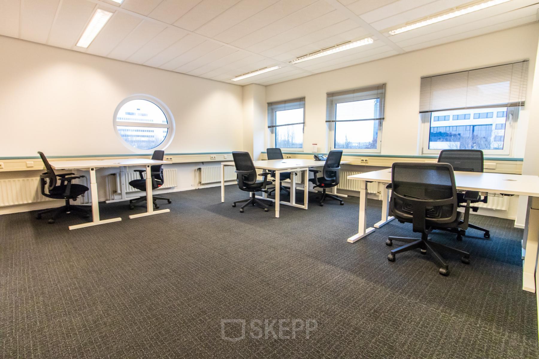 Modern office space rental at Siriusdreef 17, Hoofddorp, showcasing a well-lit room with multiple desks and chairs, ready for business productivity.