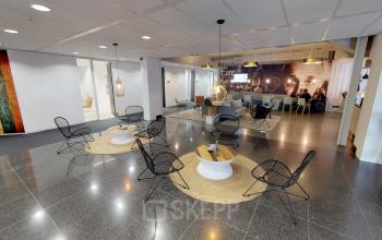 Modern office space for rent at Meidoornkade 22, Houten, featuring a furnished, open floor plan with stylish seating areas and a collaborative atmosphere.
