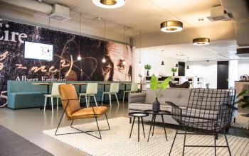 Modern office space with stylish seating and warm lighting perfect for rent. The furnished interior at Meidoornkade 22, Houten, offers a welcoming environment for office space rental.