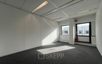 Bright office space with large windows located at Meidoornkade 22, Houten, ideal for rent. The unfurnished area offers a blank canvas for customization, perfect for office space rental.