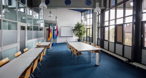 Spacious and well-lit conference room at Eurodepark 1, Kerkrade, featuring modern furniture, large windows for natural light, and presentation equipment, ideal for office space rental.