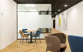 Modern office space at Industriepark 5B, Leek, featuring stylish seating arrangements and glass partition walls, ideal for office space rental.