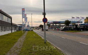 Exterior view of office buildings located on Zwettestraat 15, Leeuwarden, with flags and clear sky, ideal for rent office space.