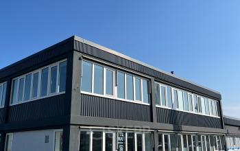 Exterior view of an office building at Zwettestraat 15, Leeuwarden, featuring large windows and a modern facade, perfect for businesses looking for office space rental.