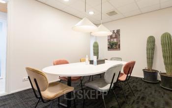 Modern office space for rent at Pompoenweg 3 - 15, Leiden with a white table, chairs, and decorative plants.
