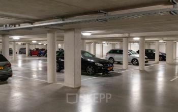Spacious underground parking area at Pompoenweg 3 - 15, Leiden, with multiple parked cars and well-lit space.