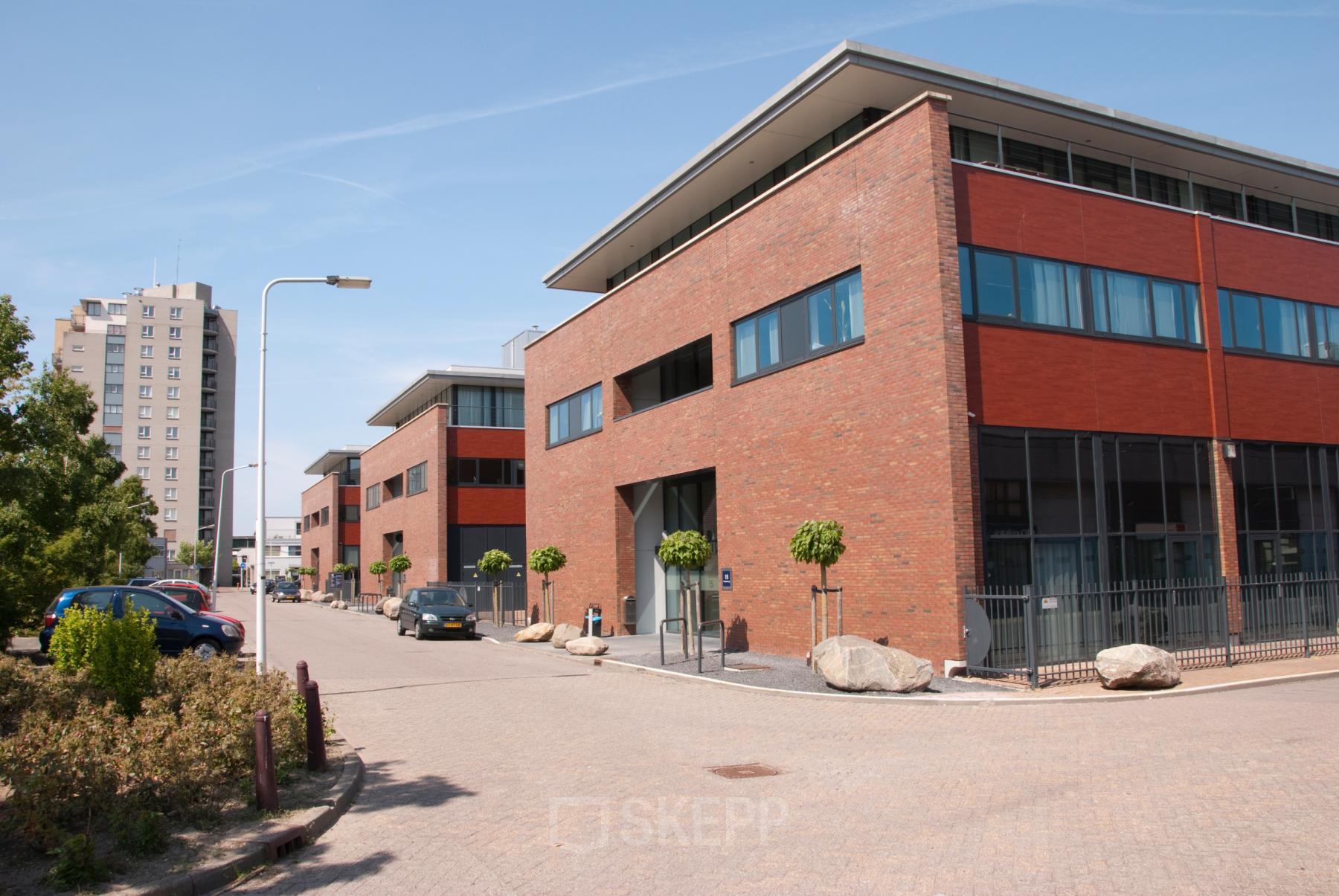 Exterior view of office buildings located at Pompoenweg 3 - 15 in Leiden, Leiden, showcasing modern brick architecture and large windows. Ideal for office space rental.