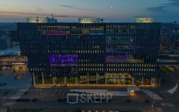Modern office space rental at Bargelaan 200, Leiden, with illuminated interiors visible during twilight.