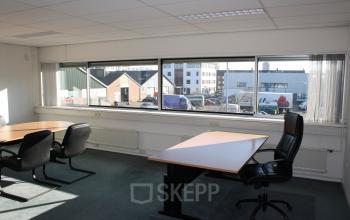 Spacious office to rent at Fruitweg 22, Leiden, featuring large windows and modern furnishings. Ideal for professionals seeking office space rental with ample natural light.