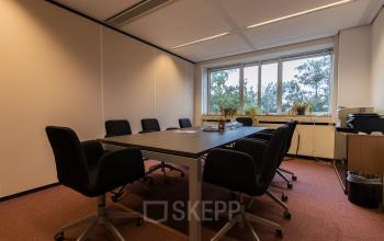 Workspace with a large table and six office chairs at Vlietweg 17, Leidschendam, available for office space rental.