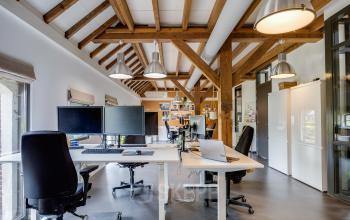 Interior view of office space rental at Hamersveldseweg 120, Leusden, featuring modern workspaces with wooden beam ceiling.