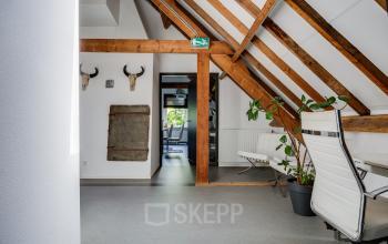 Cozy office to rent at Hamersveldseweg 120, Leusden, featuring a furnished workspace with wooden beams and modern chairs, ideal for office space rental.