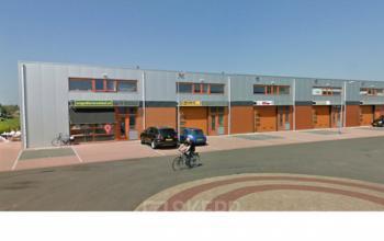 Exterior view of the office space rental at Zijakkertje 2 in Limmen, featuring a modern building facade with ample parking.