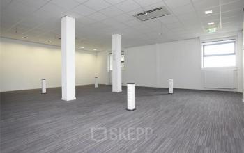 A spacious Linschoten office space rental at van Rietlaan 11, featuring modern lighting and a sleek floor.