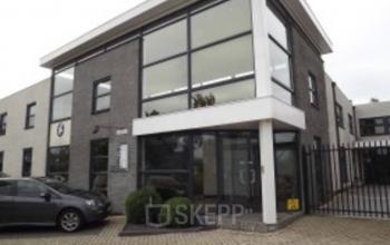 Exterior of office building located at van Rietlaan 19, Linschoten, featuring large windows and a gated entrance, ideal for office space rental.