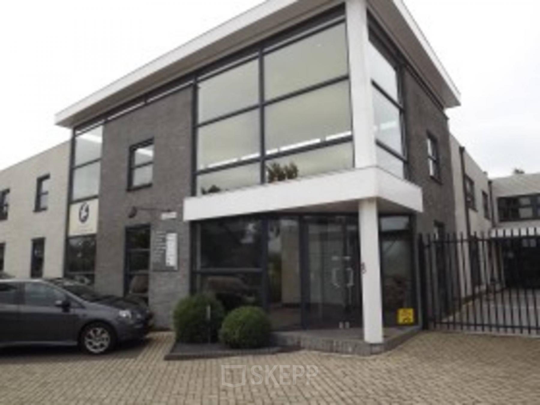 Exterior of office building located at van Rietlaan 19, Linschoten, featuring large windows and a gated entrance, ideal for office space rental.