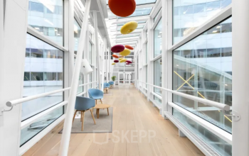 Moderne, helle Bürofläche in Linz mit Glaswänden und Sitzgelegenheiten, ideal zum Büroraum mieten.