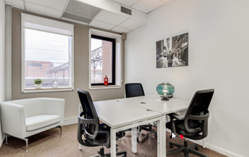 Espace de bureau partagé avec trois bureaux et un canapé confortable à la place Charles Béraudier