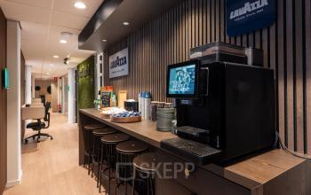 Contemporary coffee corner in office building at Horsterweg 24, featuring modern amenities and seating. Ideal for casual meetings or breaks, this stylish space complements office space rental in Maastricht-Airport for professionals.