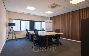 Modern office space at Horsterweg 24, Maastricht-Airport, featuring a furnished interior with desks and chairs, ideal for office space rental. Ample natural light enhances productivity.