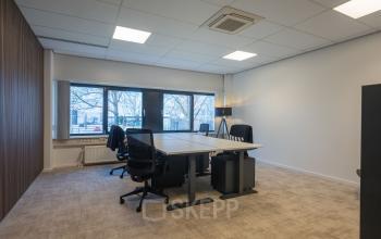 Spacious office space rental at Horsterweg 24, Maastricht-Airport featuring large windows, modern furniture, and natural light, ideal for productive work environments.