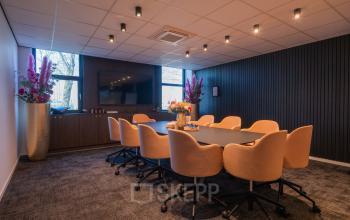 Spacious and modern conference room at Horsterweg 24, Maastricht-Airport, designed for productive meetings with a stylish table and comfortable chairs, available for office space rental.