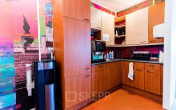 Kitchenette area in office space for rent at Europalaan 24, Maastricht-Airport, with cabinets, coffee machine, and water cooler.