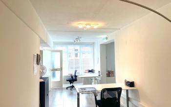Bright, furnished office space available for rent at Wilhelminasingel 44-46, Maastricht. Featuring a modern interior with desks and chairs, ideal for focused work. Perfect for those seeking office space rental.