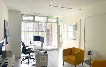 Bright office space with modern furnishings at Wilhelminasingel 44-46, Maastricht, available for rent. Features a large desk, ergonomic chair, and ample natural light.