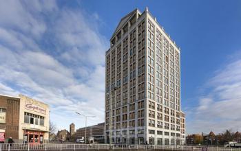 Modern office building at Stationsplein 8K, Maastricht, ideal for office space rental, showcasing its architectural design under a clear sky.