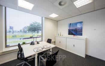 Office space rental showcased with a neat, modern workspace at Stationsplein 8K, Maastricht, featuring desks, chairs, and storage cabinets.
