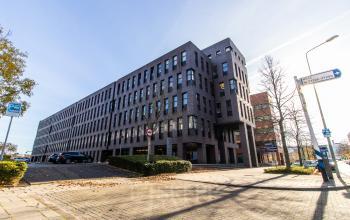 A large, modern office building at Robert Schumandomein 2, Maastricht, ideal for office space rental or finding a new office to rent.