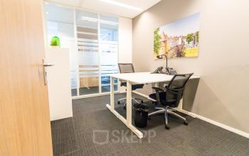Bright office space with two desks and ergonomic chairs, available for rent at Robert Schumandomein 2, Maastricht.