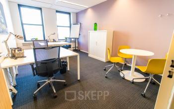 Bright office space at Robert Schumandomein 2 in Maastricht, featuring modern furniture with desks and a small meeting area, ideal for office space rental.