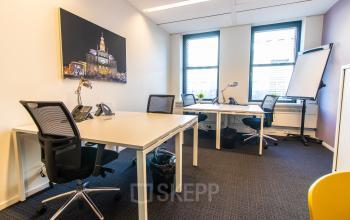 Bright office space at Robert Schumandomein 2, Maastricht, featuring multiple desks with chairs, phones, and plants, ideal for office space rental.