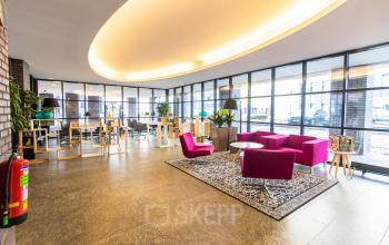 Bright office space at Robert Schumandomein 2, Maastricht, featuring stylish seating and modern decor. Perfect for office space rental with ample natural light.