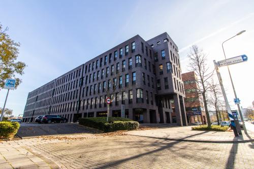A large, modern office building at Robert Schumandomein 2, Maastricht, ideal for office space rental or finding a new office to rent.