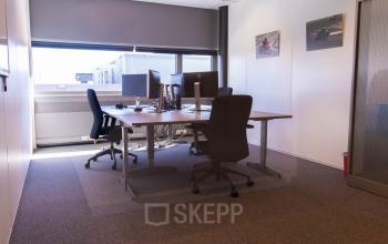 Bright office space with desks and chairs, available for rent at Brieltjenspolder 28, in Made. Ideal for office space rental needs with a cozy setup.