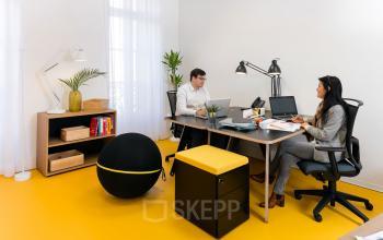 Modern office space rental at Rue de la République 113, Marseille 2 with two professionals engaged in a discussion over a computer.