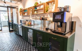 Modern pantry with coffee machine and kitchenware shelves in an office to rent at Herzogspitalstraße 24, Munich Old Town.