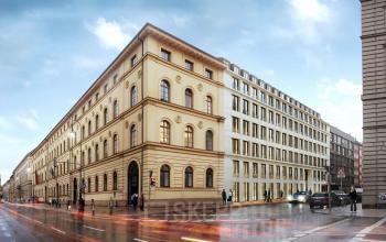 Exterior of the office building at Theresienstraße 1, in Munich Maxvorstadt, showcasing classic architecture and street view with passing cars.