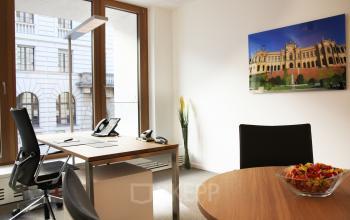 Bright, furnished office space with large windows and modern furniture at Theresienstraße 1 in Munich Maxvorstadt.