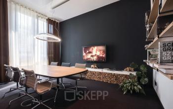 Modernes Büro in der Arnulfstraße 122-126, München Neuhausen mit Konferenztisch und Bildschirm.