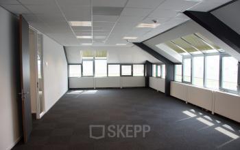 Bright office space rental at Rijksweg 79, Naarden, featuring large windows and modern lighting.