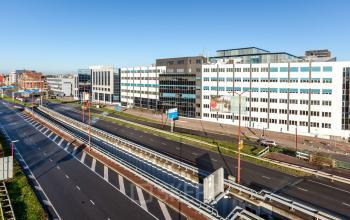 Exterior view of the office building located at Zoomstede 13-25, Nieuwegein, Nieuwegein, showcasing a modern facade along a busy road for office space rental.