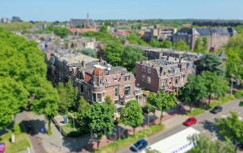 Exterior view of the office building at Oranjesingel 51, Nijmegen, surrounded by trees and cityscape. Perfect for those seeking unique office space rental in a vibrant neighborhood.